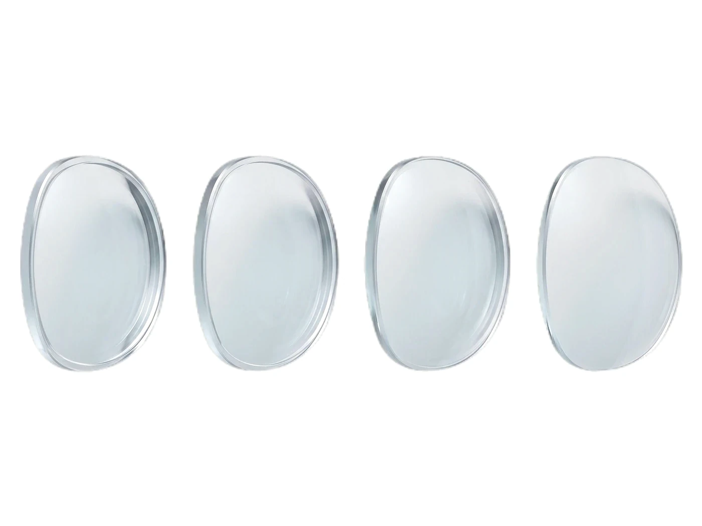 Four clear lens blanks in a row, each ground to a different prescription, the edge thickness changing from one to the next
