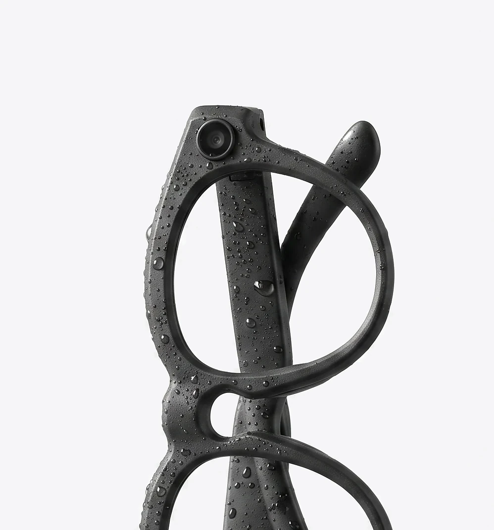 The AURVIZ o1 smartglasses folded and standing on end, beaded with water