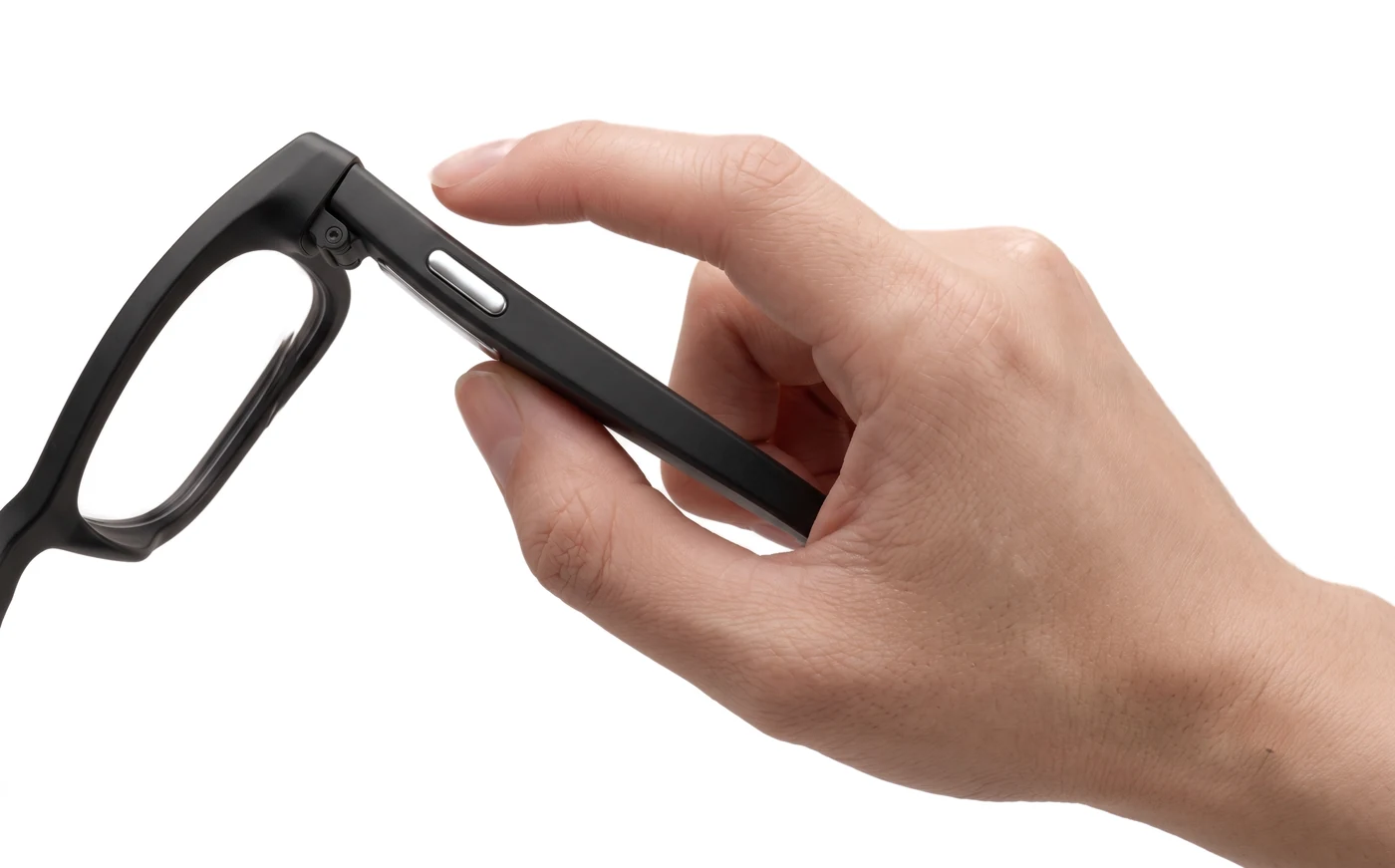 A hand holding the AURVIZ o1 by its temple, a finger about to press the silver action button
